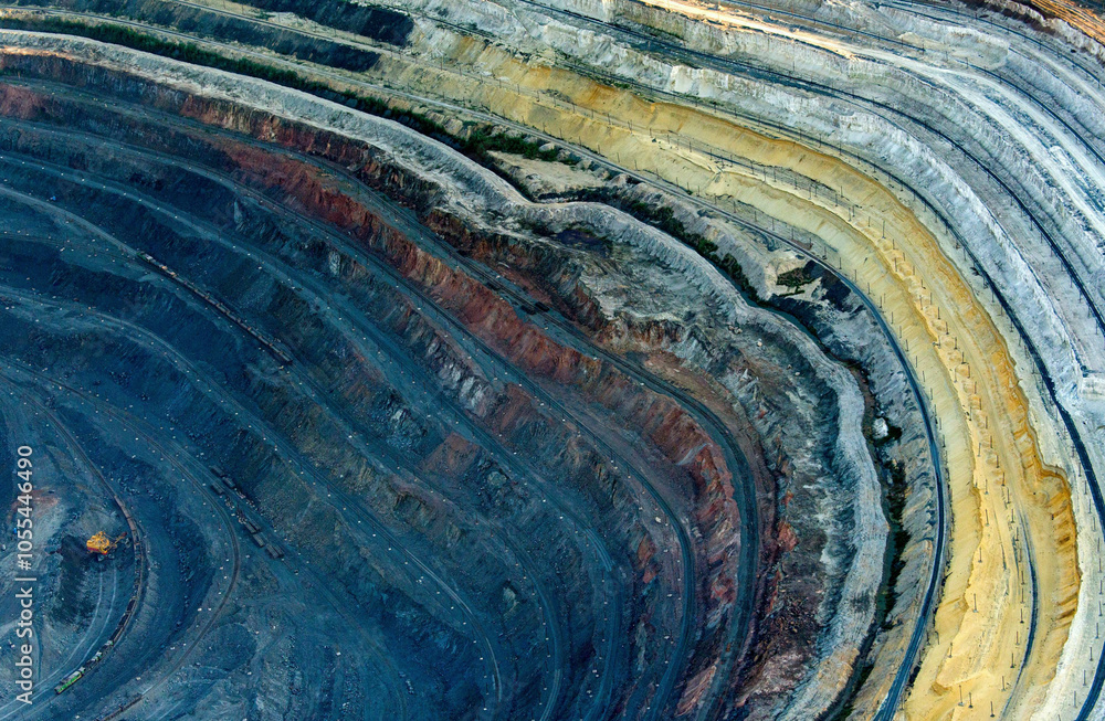 Aerial view of colorful pit mine with exposed layers and scarred terrain, Belgorod Oblast, Russia. Aerial view of colorful pit mine with exposed layers and scarred terrain, Belgorod Oblast, Russia.