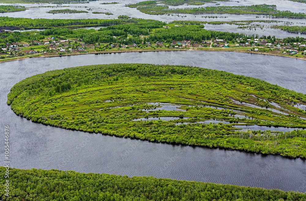 Aerial view of the winding Amgun River with lush vegetation and a serene island, Khabarovsk Krai, Russia. Aerial view of the winding Amgun River with lush vegetation and a serene island, Khabarovsk Krai, Russia.