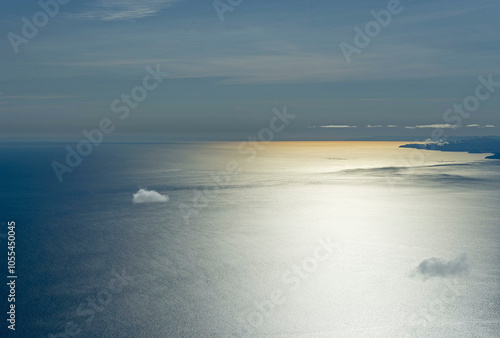 Aerial view of serene and tranquil Baikal Lake with sunlight reflection and expansive sky, Irkutsk Region, Russia. photo