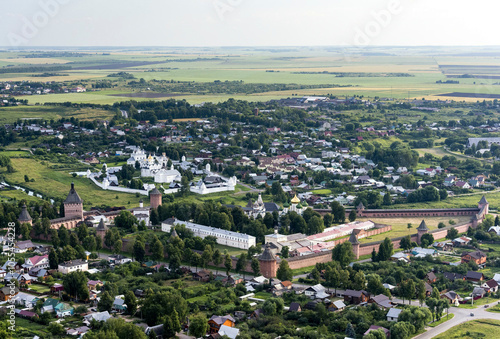 Aerial view of the historic town with beautiful monasteries and kremlin surrounded by green fields and rooftops, Suzdal, Russia. photo