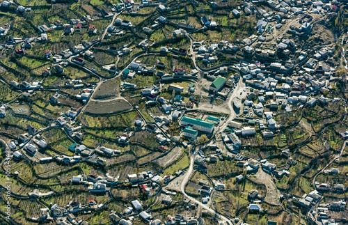 Aerial view of picturesque rural village with scattered homes and fields, Dagestan Republic, Russia. photo