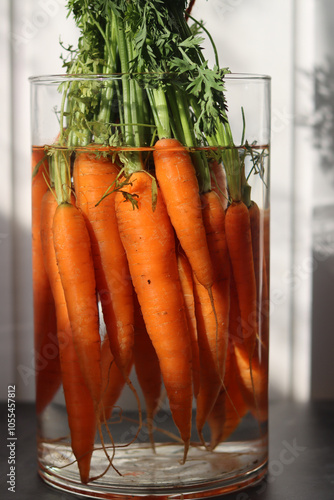 Fresh organic carrots in a glass jar. Close up photo of farm vegetable. Carrot texture. Healthy food concept. photo