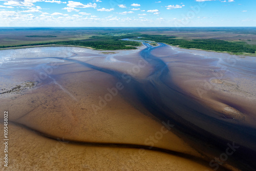 Aerial view of serene Onega Bay with tranquil water, lush forest, and expansive sky, Karelia Republic, Russia.