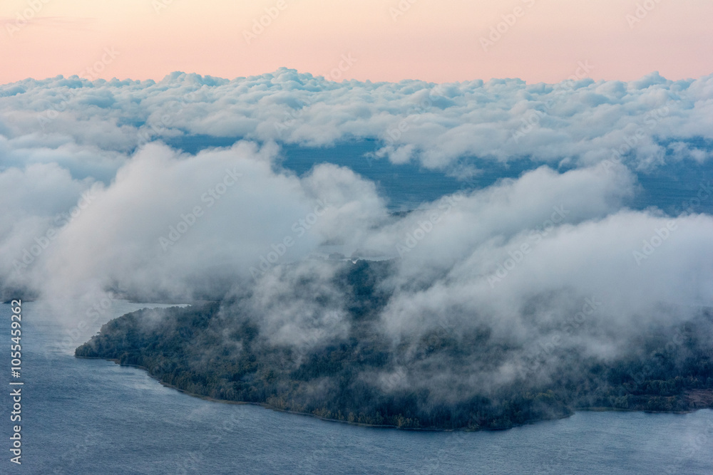 Aerial view of tranquil Ladoga Lake with drifting clouds and a picturesque island, Karelia Republic, Russia. Aerial view of tranquil Ladoga Lake with drifting clouds and a picturesque island, Karelia Republic, Russia.