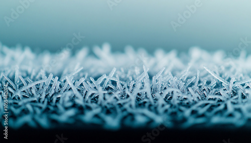 Frost patterns on a surface, cool tones, nature's intricate design. photo