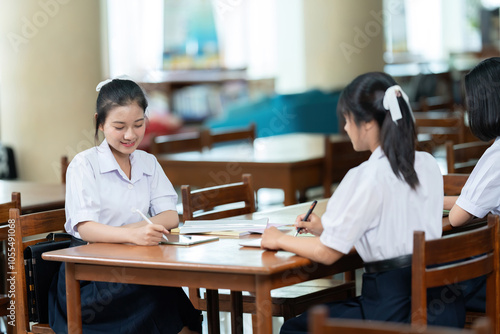 The library serves as a beacon of knowledge for the Asian high school girl with long hair, who frequently engages with books that enhance her educational experience and inspire her future aspirations.