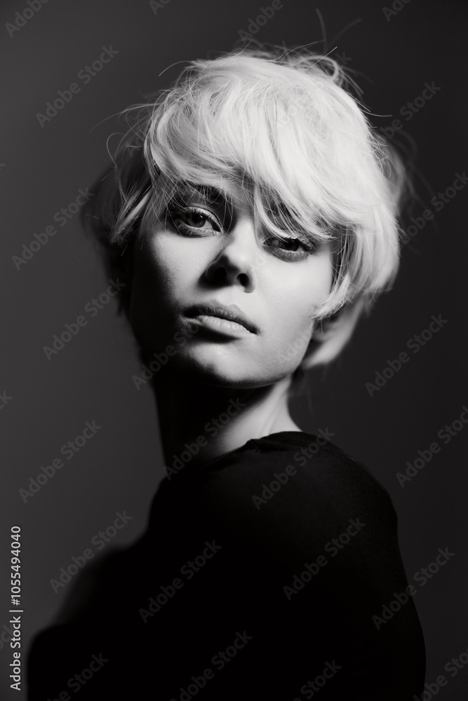 © SHOTPRIME STUDIO - Elegant young woman with short blonde hair, posing confidently in a dark setting, exuding a mysterious and artistic vibe through her thoughtful expression. © SHOTPRIME STUDIO - Elegant young woman with short blonde hair, posing confidently in a dark setting, exuding a mysterious and artistic vibe through her thoughtful expression.