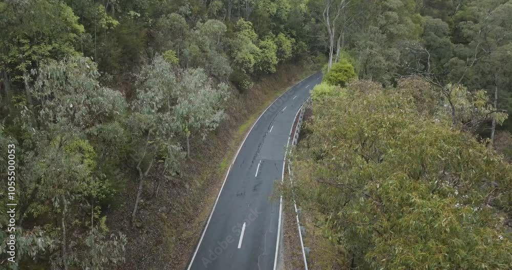 Aerial view of winding road through beautiful forest and greenery, Alpine National Park, Victoria, Australia. Aerial view of winding road through beautiful forest and greenery, Alpine National Park, Victoria, Australia.