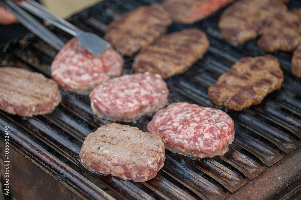 Meat is being grilled on a barbecue Meat is being grilled on a barbecue