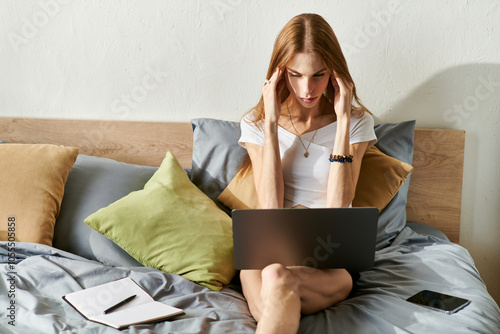 Photos A young woman with anorexia engaged with her laptop and feeling stress