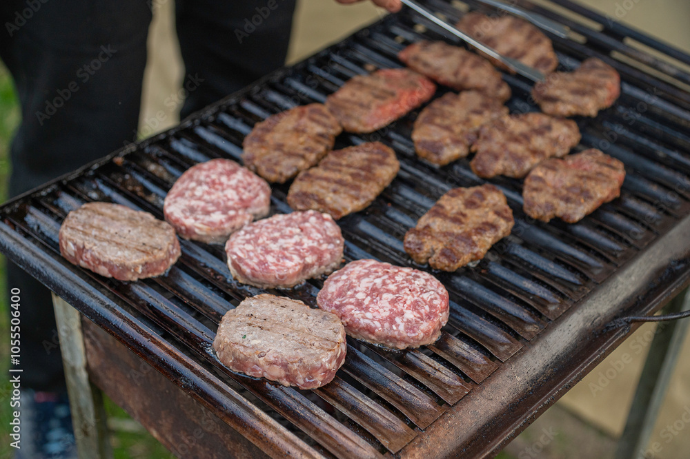 Meat is being grilled on a barbecue Meat is being grilled on a barbecue