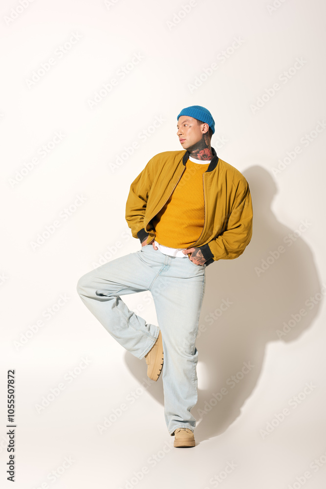 A young man with striking tattoos showcases his fashion sense while posing artistically. A young man with striking tattoos showcases his fashion sense while posing artistically.