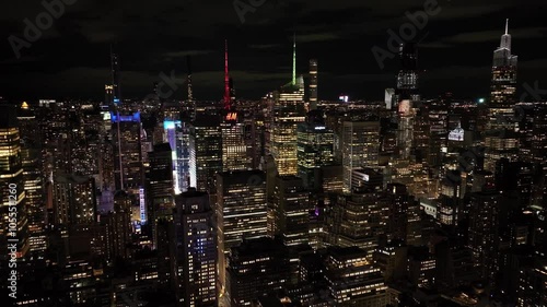 Aerial view of vibrant times square illuminated at night with bustling city lights and skyscrapers, New York City, United States.