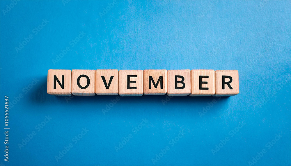 Wooden cubes with text NOVEMBER on blue backdrop. Autumn season. Month of year. Wood block Wooden cubes with text NOVEMBER on blue backdrop. Autumn season. Month of year. Wood block