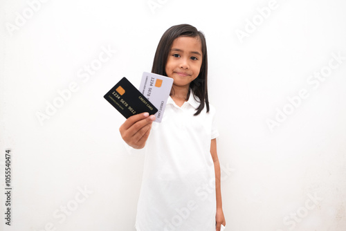 portrait of little girl holding credit card isolated white background