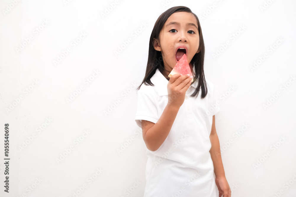 Cute little Asian girl enjoying watermelon isolated on white background Cute little Asian girl enjoying watermelon isolated on white background