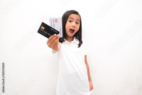 portrait of little girl holding credit card isolated white background