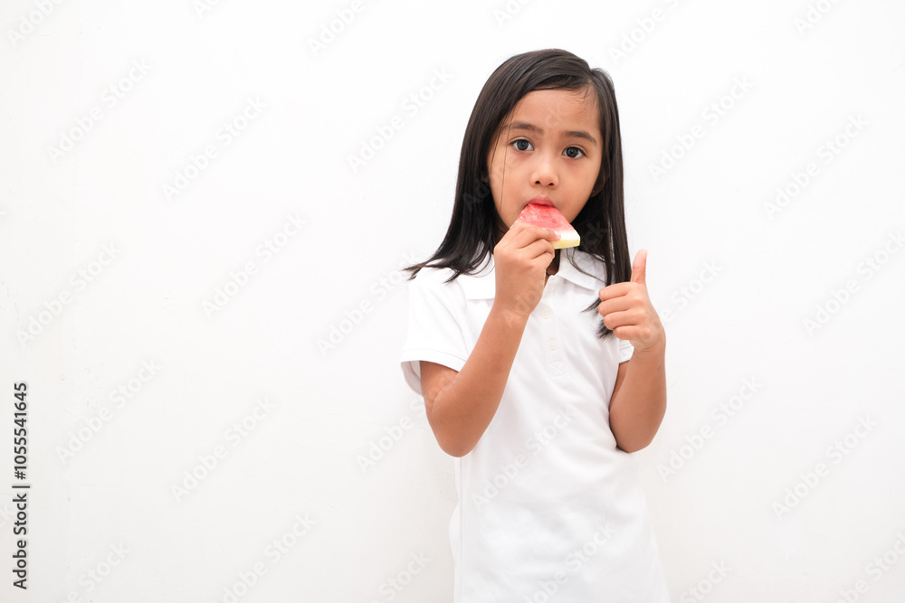 Cute little Asian girl enjoying watermelon isolated on white background Cute little Asian girl enjoying watermelon isolated on white background