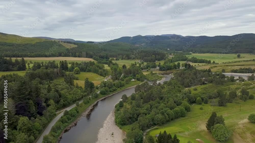 Aerial view of a picturesque village with a serene river and a beautiful bridge surrounded by lush greenery and hills, Balletar, Scotland. Aerial view of a picturesque village with a serene river and a beautiful bridge surrounded by lush greenery and hills, Balletar, Scotland.