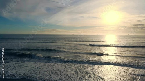 Aerial view of serene ocean waves at sunset with a picturesque horizon and tranquil sky, Huntington Beach, United States of America. photo