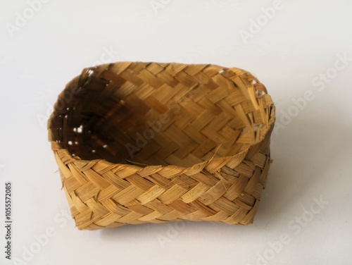 Indonesian traditional besek or a food container made of woven bamboo isolated white background. DIY  food container usually used for traditional event photo