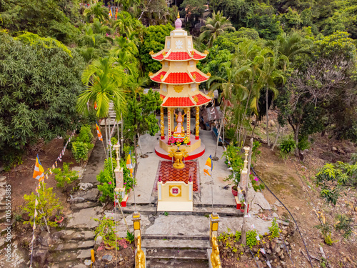 The Buddhist temple in the rock.

Suoi Do Pogoda. There is a waterfall in the rock near the pagoda. Not far from Nha Trang. Cloudy weather. Shooting from a drone. photo