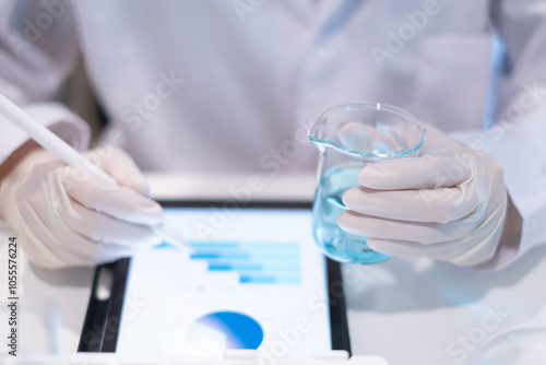 Scientist holding test tube beaker laboratory results report on tablet for data analysis online study science research technology biology chemistry medical discovery experiment innovation development