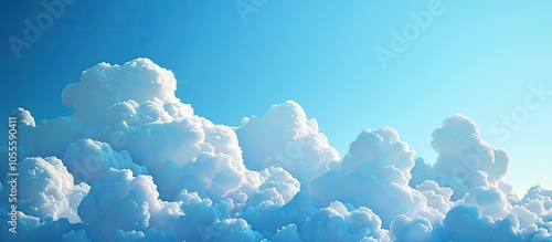 Cumulus clouds create a picturesque scene against a clear blue sky in this natural background image with copy space