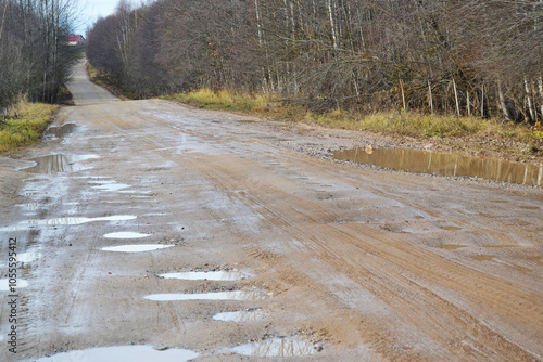 The village road in the pits is in poor condition in autumn after rains photo