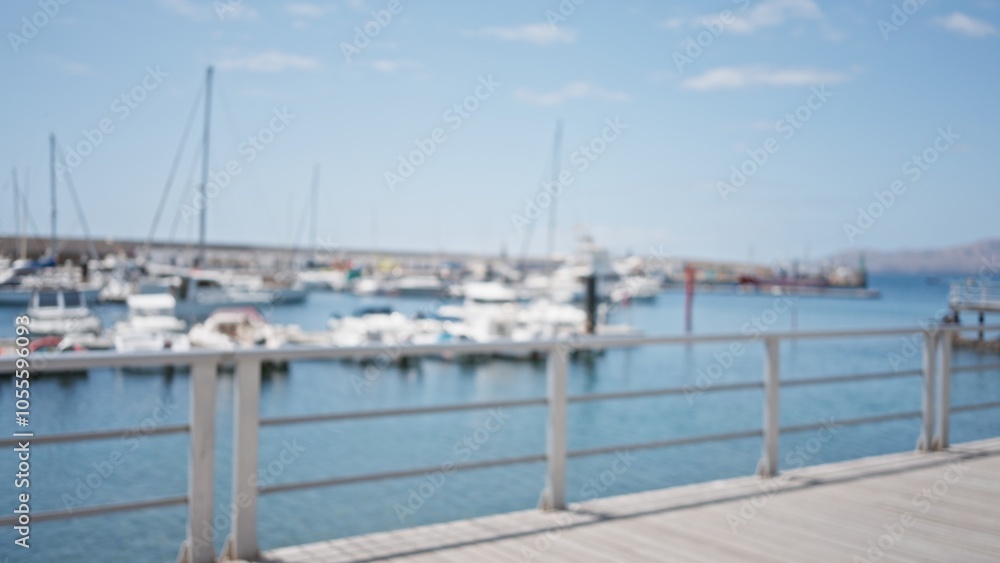 Blurred marina with yachts and a defocused background on a sunny day showcasing the seaside atmosphere and nautical setting at a dock.