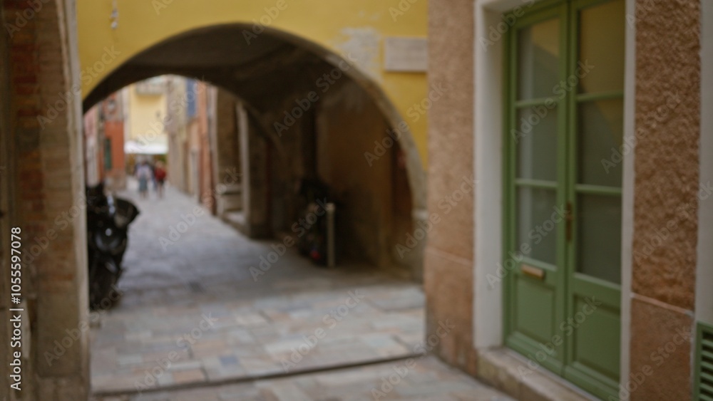 Blurred street scene in villefranche-sur-mer with stone alley, archway, and pastel facades under soft daylight, evoking the charm of an old french town. Blurred street scene in villefranche-sur-mer with stone alley, archway, and pastel facades under soft daylight, evoking the charm of an old french town.
