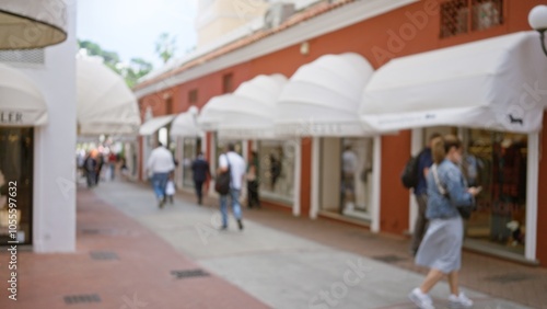 People stroll along a luxurious shopping street on capri island with blurred backgrounds, showcasing a relaxed atmosphere under elegant awnings. photo