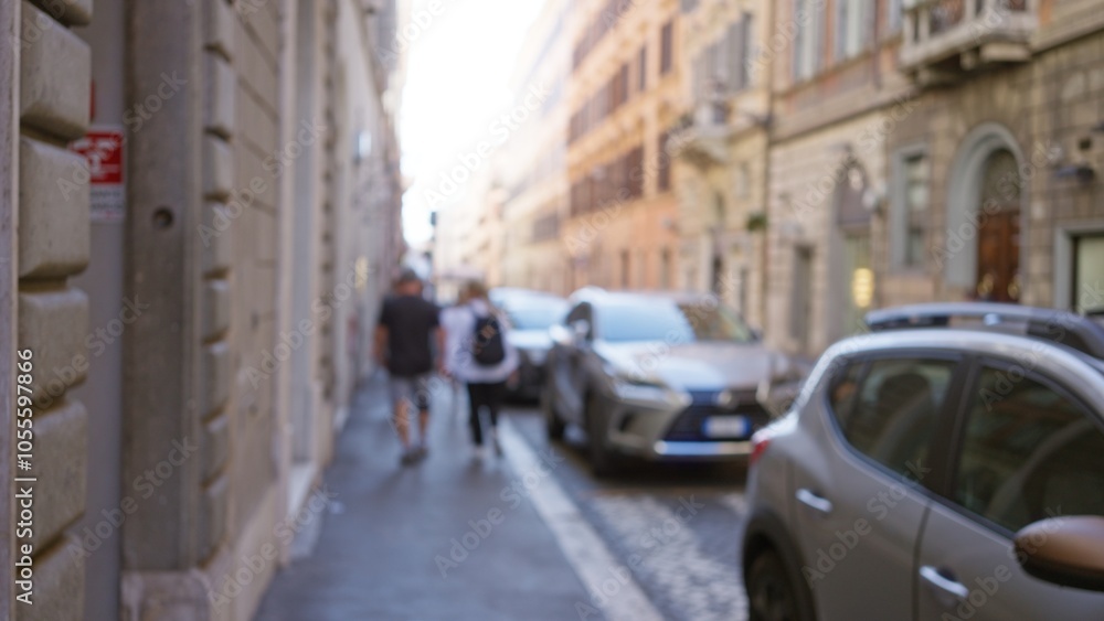 Blurred image captures a couple walking on a historic street in rome, italy, with cars parked alongside and an out-of-focus vintage architecture creating a bokeh effect. Blurred image captures a couple walking on a historic street in rome, italy, with cars parked alongside and an out-of-focus vintage architecture creating a bokeh effect.