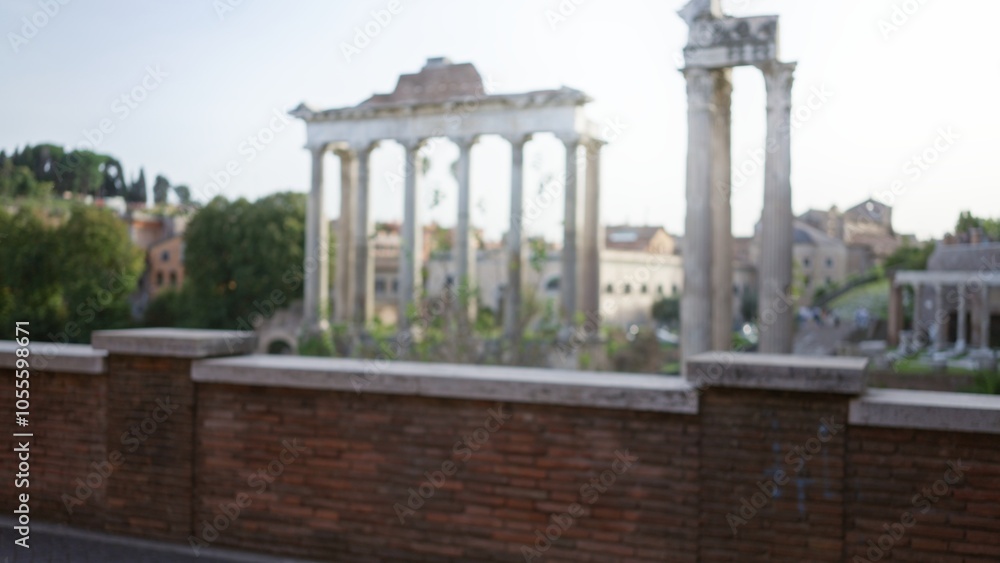 Obraz premium Blurred view of the historic roman forum ruins with ancient columns under a clear sky, capturing the timeless essence of rome's architectural grandeur.