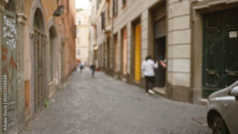 Blurred street view in old town rome with people in the distance and historic buildings lining the cobblestone path creating a nostalgic and atmospheric urban scene. Blurred street view in old town rome with people in the distance and historic buildings lining the cobblestone path creating a nostalgic and atmospheric urban scene.