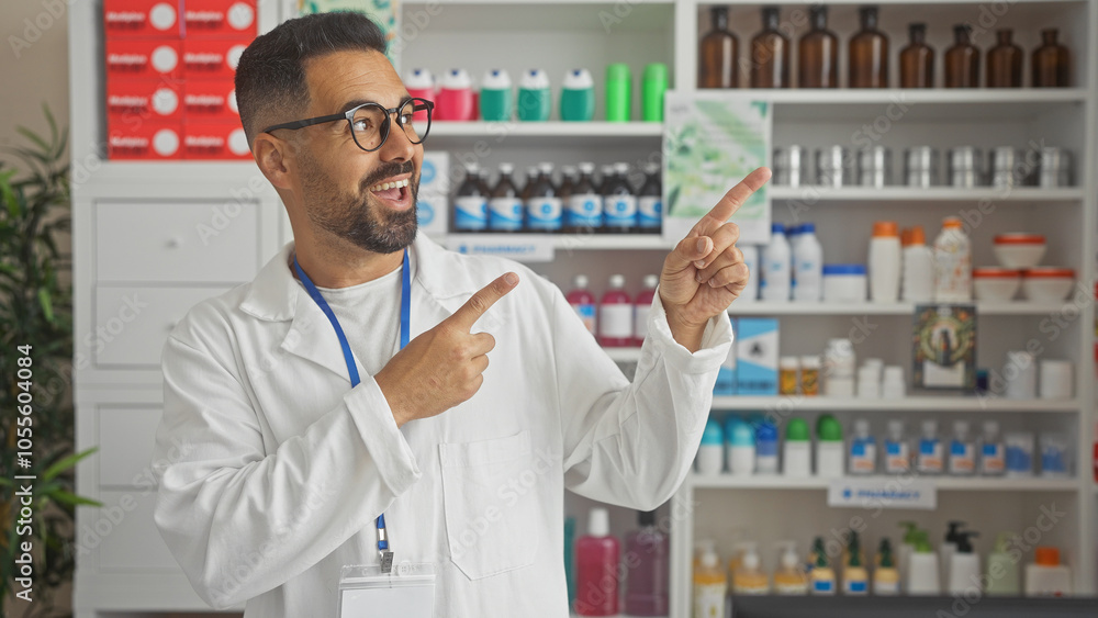 Fototapeta premium Handsome pharmacist smiling and pointing at products in a modern drugstore