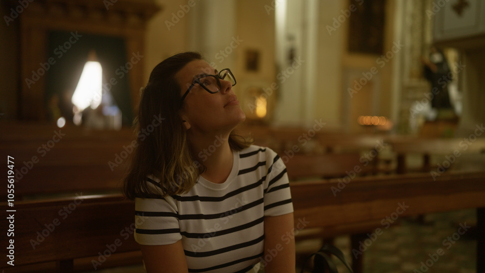 Young, beautiful hispanic woman seated in an italian church, looking upward with a thoughtful expression in a serene christian setting. Young, beautiful hispanic woman seated in an italian church, looking upward with a thoughtful expression in a serene christian setting.