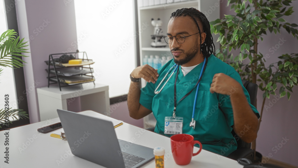 Young man with braids in a clinic setting wears scrubs and stethoscope, sitting at a desk with a laptop, red mug, and medical documents in a modern hospital office. Young man with braids in a clinic setting wears scrubs and stethoscope, sitting at a desk with a laptop, red mug, and medical documents in a modern hospital office.