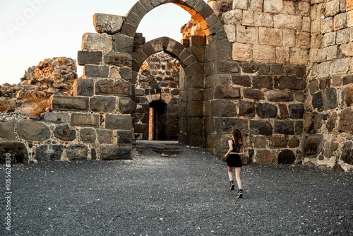 Young Girl Exploring Ancient Ruins at Sunset
