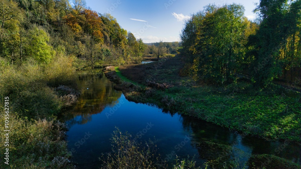 Serene river landscape with lush green trees. Serene river landscape with lush green trees.