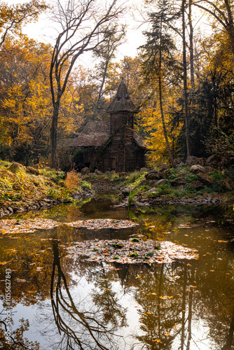 A photo of a small cabin sits in the middle of a pond