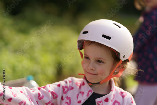 Little cute girl in helmet close up. Childhood fun concept