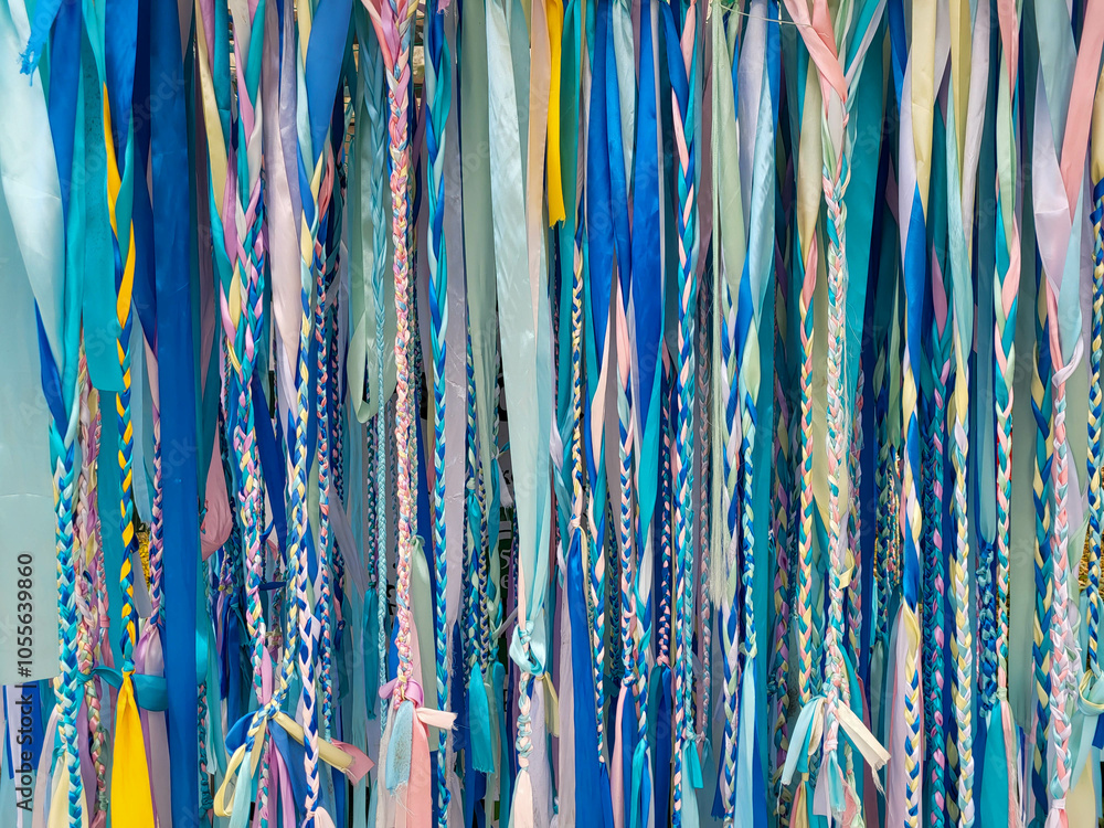 Background of braided multicolored pigtails made of ribbons Background of braided multicolored pigtails made of ribbons