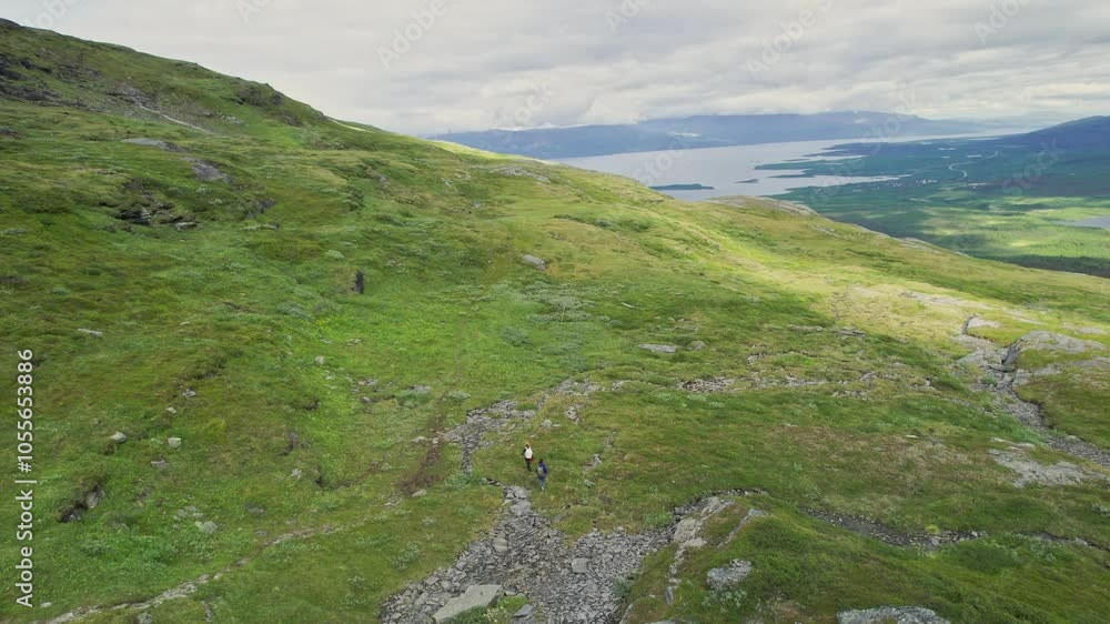 Aerial view of a breathtaking landscape with winding trails and majestic mountains in Abisko National Park, Sweden. Aerial view of a breathtaking landscape with winding trails and majestic mountains in Abisko National Park, Sweden.