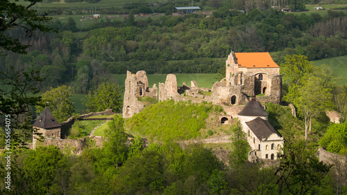 Aerial view of Potštejn Castle on a beautiful summer day, standing as a dominant feature over the surrounding landscape.