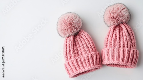 Two pink knitted hats displayed against a white background representing a winter fashion theme photo