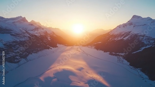 A stunning aerial view of a snowy glacier during an idyllic sunrise in the mountains