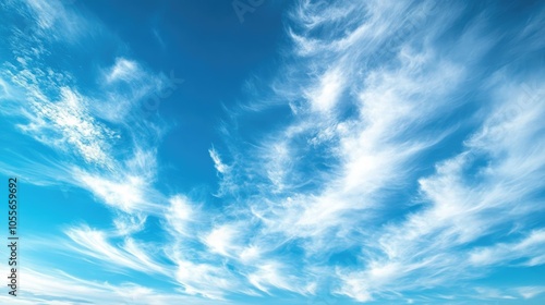 Vivid blue sky adorned with delicate cirrus clouds