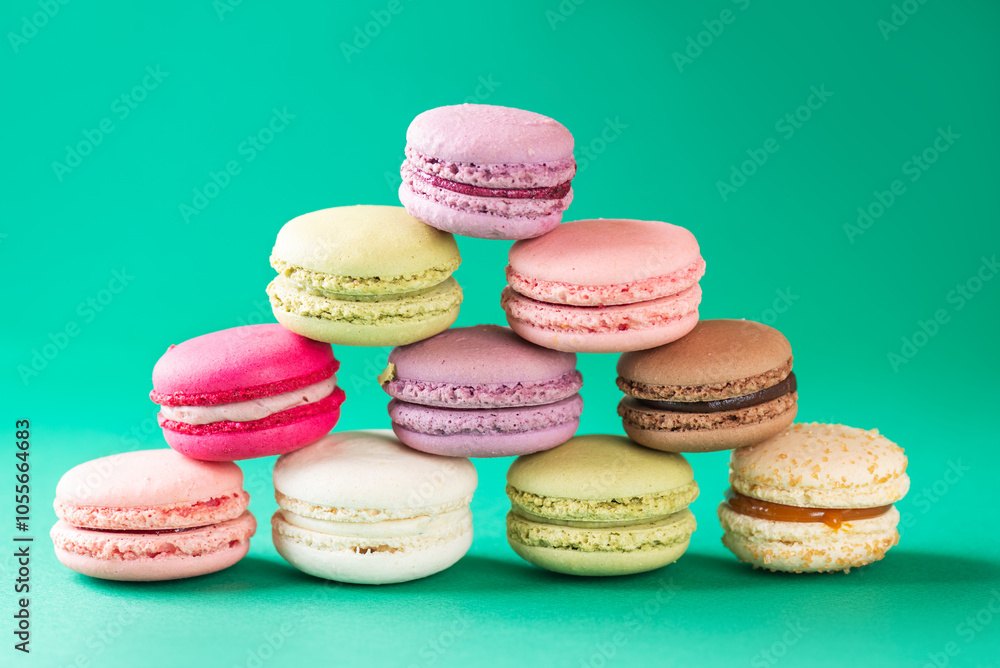 Macarons in the form of a Christmas tree or pyramid with star on a green and red background. Macarons in the form of a Christmas tree or pyramid with star on a green and red background.