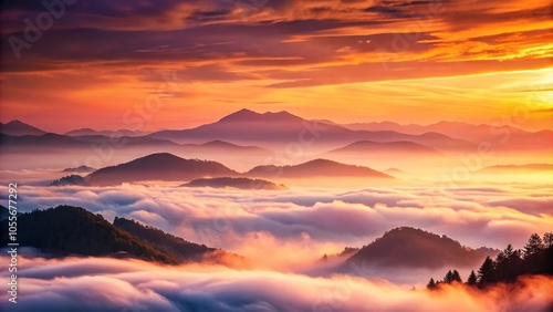 Soft pinks and oranges of sunset blend seamlessly into the misty veil of an early morning mountain range, peaceful, ethereal scene